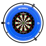 A blue circular dartboard surround with a mounted Winmau Blade dartboard in the center. The surround features the brand name 'AUTODARTS' at the top and text reading 'Automatic dart scoring for everyone' near the bottom, with target icons on the sides.
