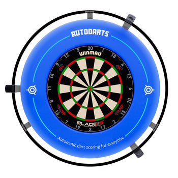A blue circular dartboard surround with a mounted Winmau Blade dartboard in the center. The surround features the brand name 'AUTODARTS' at the top and text reading 'Automatic dart scoring for everyone' near the bottom, with target icons on the sides.