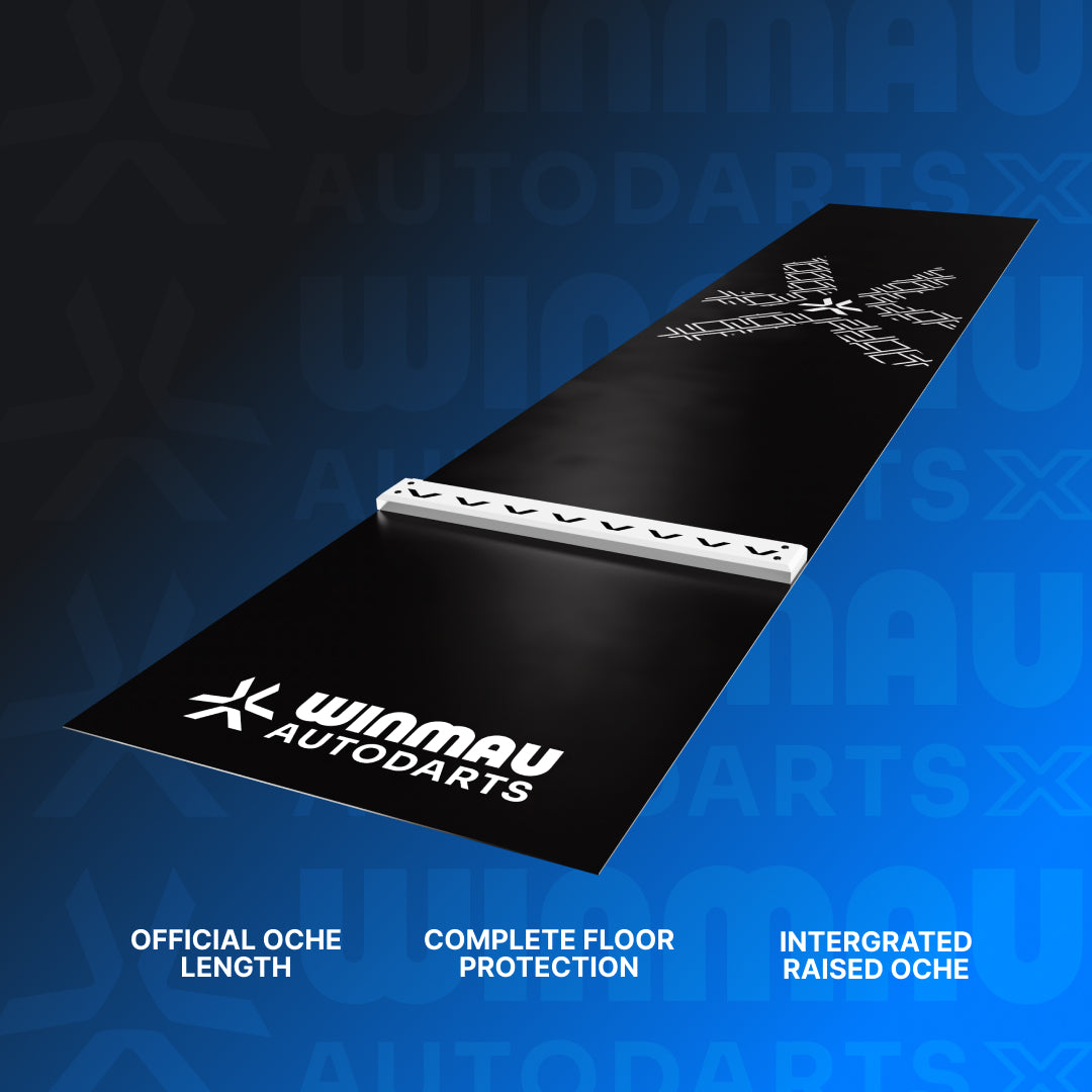 A black Winmau Autodarts official floor mat shown at an angle on a blue gradient background, featuring the white Autodarts logo, a raised white integrated oche bar, and feature text "official oche length", "complete floor protection" and "integrated raised oche" at the bottom.