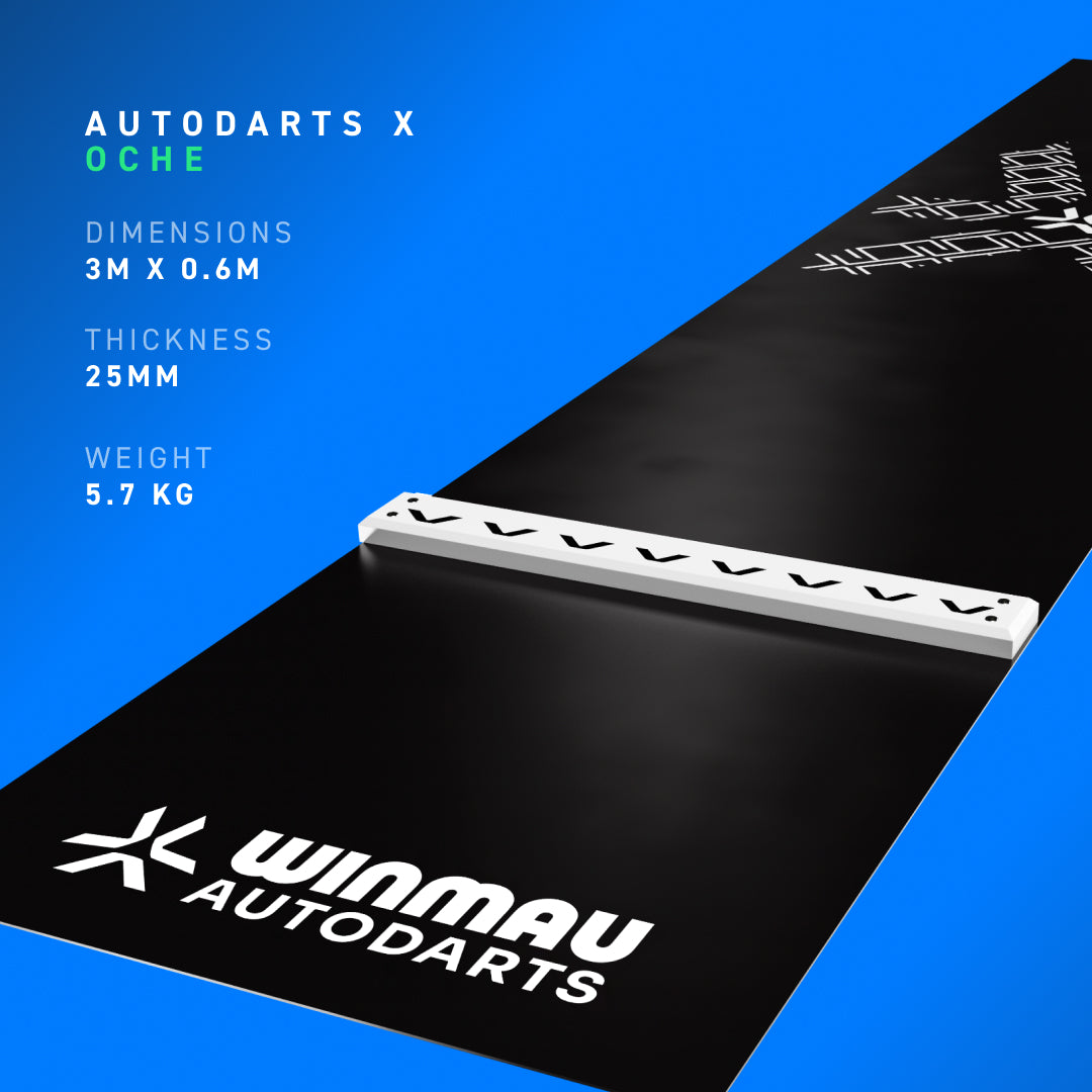 A black Winmau Autodarts official floor mat shown at an angle on a blue gradient background, featuring the white Autodarts logo, a raised white integrated oche bar, and product specifications "dimensions 3m x 0.6m", "thickness 25mm", "weight 5.7kg" on the left.